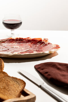 Serrano ham plate with a glass of whine, mediterranean appetizer food.