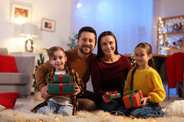 Happy family with Christmas gifts on floor in festive decorated room