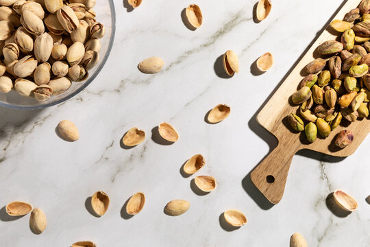 Top view of peeled pistachio nuts on kitchen countertop surface