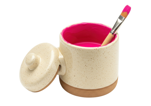 Isolated ceramic mug with lid and paintbrush filled with pink paint for artistic endeavor