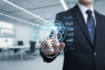 Businessman uses a futuristic interface to show a business management cycle.