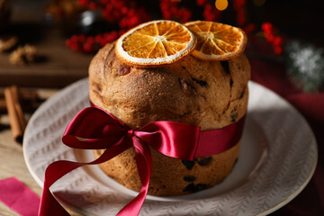 Christmas food. Delicious Panettone cake, spices and festive decor on table, closeup