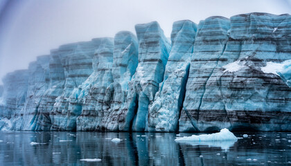 Serene landscape of a large blue glacier floating in icy water with a subtle gradient sky