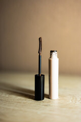 Brown mascara bottle with unique brush for eye makeup.