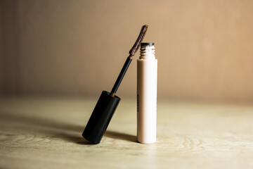 Brown mascara bottle with unique brush for eye makeup.

