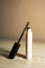 Brown mascara bottle with unique brush for eye makeup.

