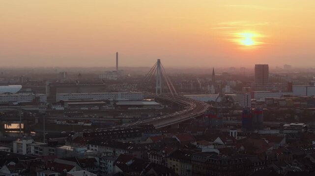 Aerial panorama of Mannheim, Germany, during a vibrant sunset with traffic over Kurt Schumacher Brucke bridge bridge