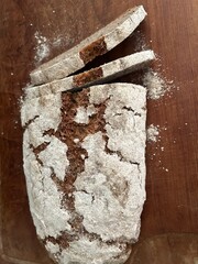 freshly baked sourdough bread sliced on wooden cutting board, directly above