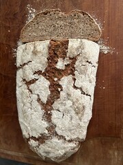 freshly baked sourdough bread sliced on wooden cutting board, directly above