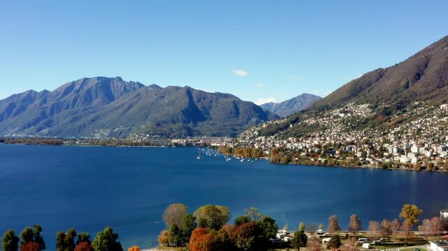 Aerial footage taken with a drone over Lake Maggiore in the canton of Ticino, Switzerland. A sunny autumn day with very clear skies.