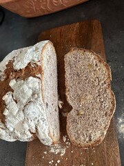 freshly baked sourdough bread sliced on wooden cutting board, directly above