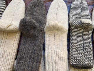 Handmade woolen socks in natural colors on display