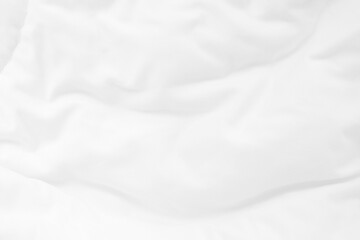 Close up top view of white bedding sheet and wrinkle messy blanket in bedroom after wake up in the morning.