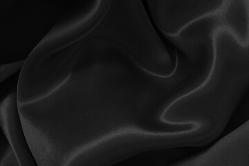 Black fabric cloth texture for background and design art work, beautiful crumpled pattern of silk or linen.
