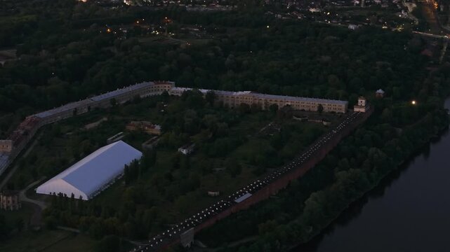 Aerial cinematic footage of historic Modlin Fortress illuminated at dusk