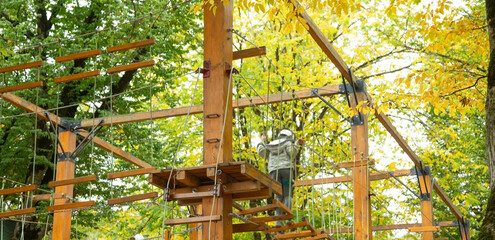 Wooden playground with a suspended ropes.