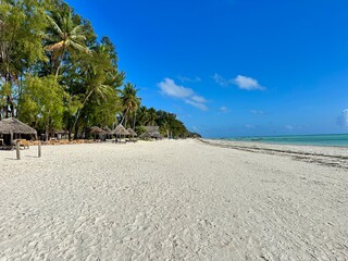 Paje Beach Zanzibar Tanzania – Tropical White Sand Shoreline with Turquoise Indian Ocean Waves under Clear Blue Sky