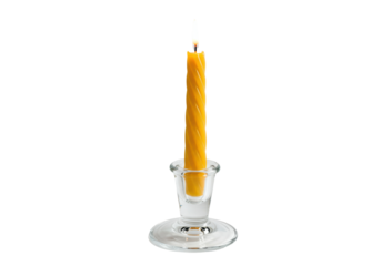 Isolated burning beeswax candle in clear glass candle holder, illuminated wick flame