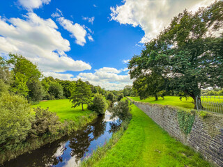 River and stone wall in green landscape at Lough Rynn Estate, County Leitrim, Ireland