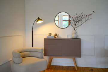 view of a cozy decorative nook with a table lamp emitting a warm glow.