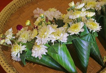 Heap of flower bouquets for offering Lord Buddha for sale in the Buddhist temple in Thailand