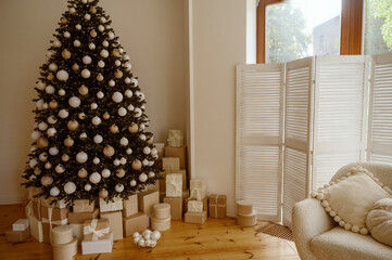 Beautifully decorated Christmas tree with many presents under it.