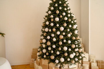 Beautifully decorated Christmas tree with many presents under it.