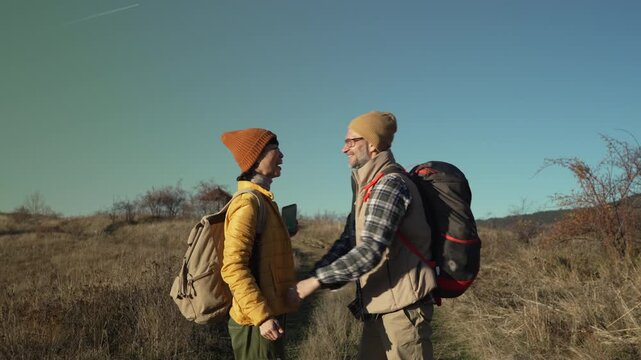 Romantic couple of hikers embracing during autumn trek