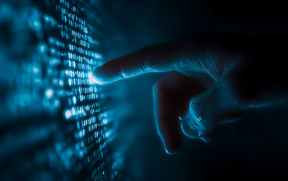 Close up of a human hand interacting with a glowing blue digital data stream