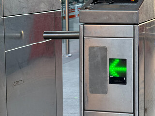 Green arrow on public transport turnstile indicating access granted