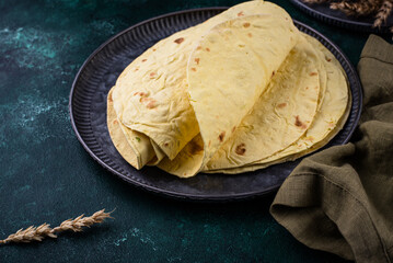 Lavash flat bread on green background