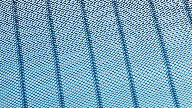 Mosquito net gently swaying in the wind near an open window during a calm afternoon