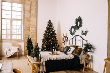 Minimalistic holiday interior with natural shades, soft textures and Christmas decor.