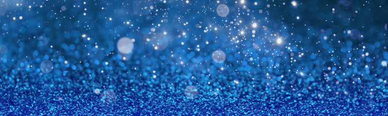 Christmas background with blue glitters and bokeh lights. Banner design