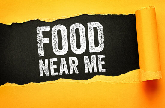 Food Near Me phrase highlighted on ripped paper background. Concept for dining search, eating out, local meals, restaurant discovery, and nearby food options