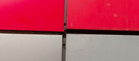 Red and white panels with metal seams and screws image