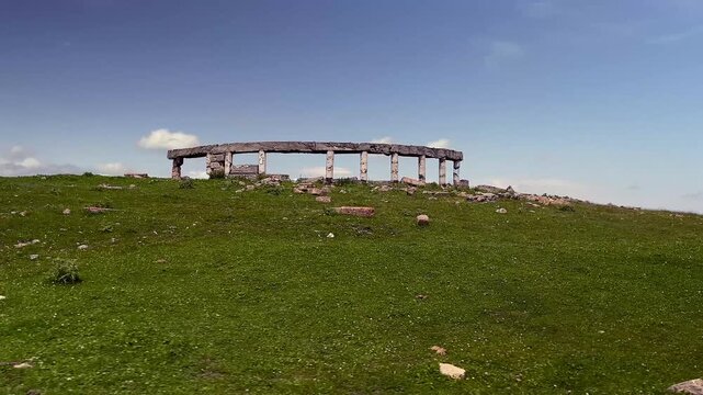 Ruins with columns. Driving on a remote mountain road in the Caucasus, offroad 4x4 vehicle POV in a scenic highland valley
