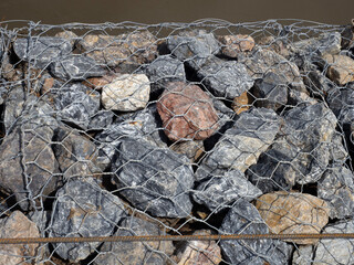 A tightly constructed wall of rocks and wire.