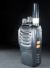 Handheld transceiver with short antenna on a black background