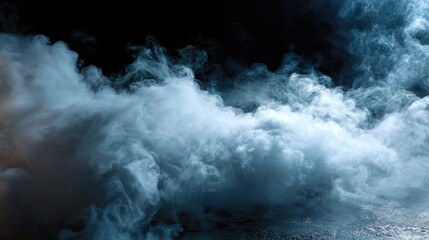 Fototapeta premium A swirling mass of blue and white smoke creates a dramatic, ethereal atmosphere against a dark background.