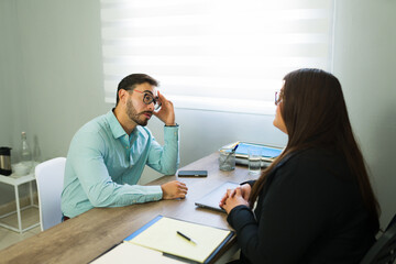 Stressed man receiving legal advice from attorney