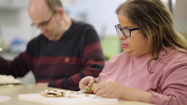 People with disabilities learning to cook in a classroom