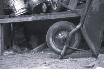 Monochrome Still Life - Wheelbarrow and Assorted Objects in a Yard.