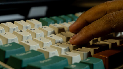 Finger pressing keys on a mechanical keyboard, detailed focus on fingertips and QWER row, background gradually blurred emphasizing typing activity.