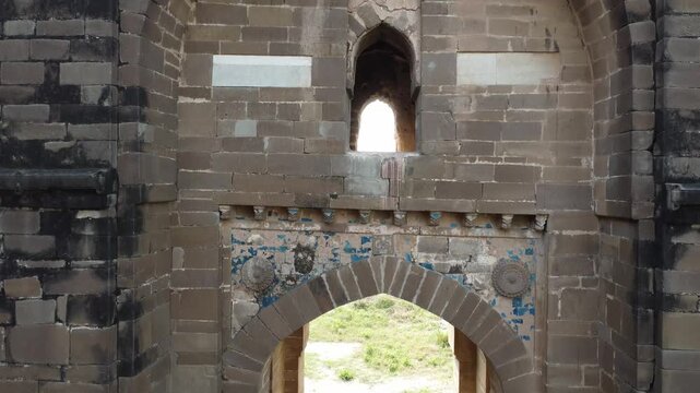 Detailed view of Rohtas Fort Shishi Gate showing ancient carved stone wall and Mughal artistry