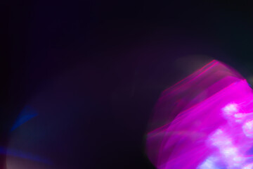 Colorful light leak on black background, abstract design with optical lens flare shot on a long lens