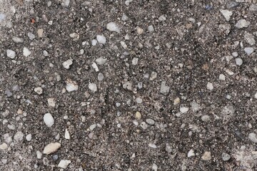 Close-up of a rough, textured, and detailed asphalt surface.
