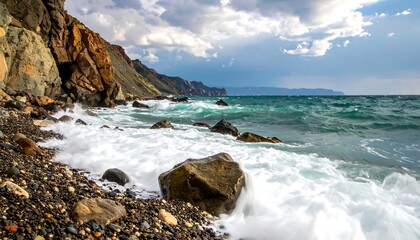 Rocky shoreline with crashing waves beneath a dramatic sky, showcasing natural coastal beauty and rugged terrain