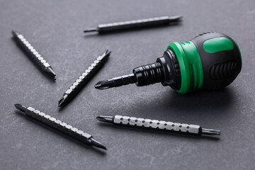 Stubby Screwdriver with bit on grey background