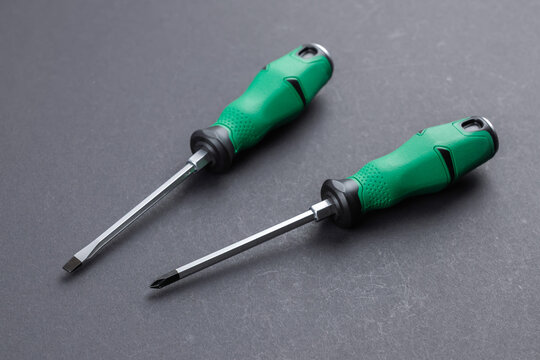 Screwdrivers. Instruments. Two screwdrivers on a dark background